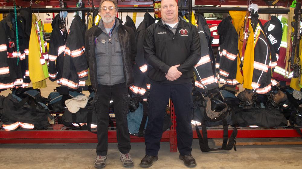 Gary Fox with the town of Rockingham and Bellows Falls Fire Chief Shaun McGinnis stand next to firefighter gear