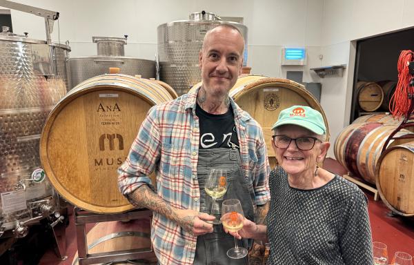 Sally Cowal lifts a glass with assistant winemaker Joshua Riesner