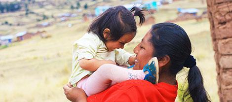 Image of a mother and daughter smiling 