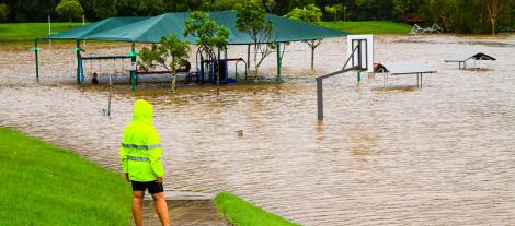 Image of a person standing in a flooded park