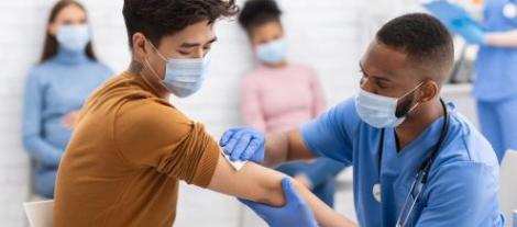 nurse administering covid shot