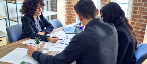 photo of woman speaking with customers at work