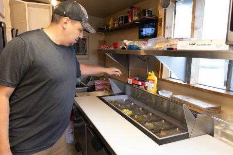 Man looks at food prep table
