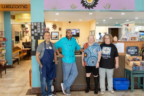 Workers standing in a row in front of counter