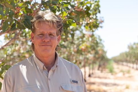 Man standing in front of row of trees