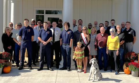 Group gathered in front of building for ribbon cutting.