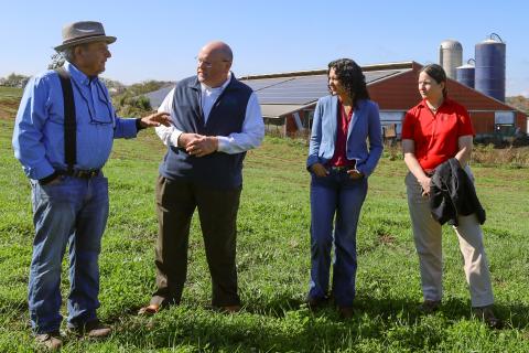 Richard Perkoski (left), owner of Main Street Milk LLC, Bob Morgan (middle), state director of U.S. Department of Agriculture (USDA) Rural Development in Pennsylvania, and USDA Deputy Secretary of Agriculture Xochitl Torres Small (right), and State Executive Director, Heidi Secord (far right), of the Farm Service Agency, speak to a small crowd at the Main Street Milk Farm in Somerset, Pa., on Nov. 3, 2024.
