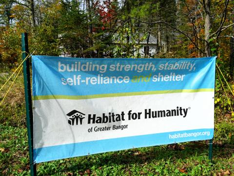 The photo shows a banner from Habitat for Humanity of Greater Bangor that was on the lawn of the new home for the ribbon-cutting ceremony.