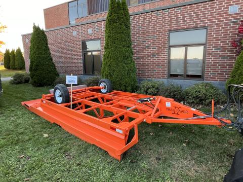 The Cold Mountain Snowmobile Clubs "Trail Paver II" dragger is shown on a lawn in front of a brick building. 