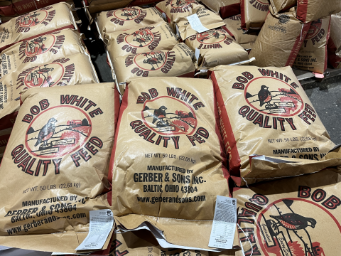Bags of livestock feed stacked on a pallet.