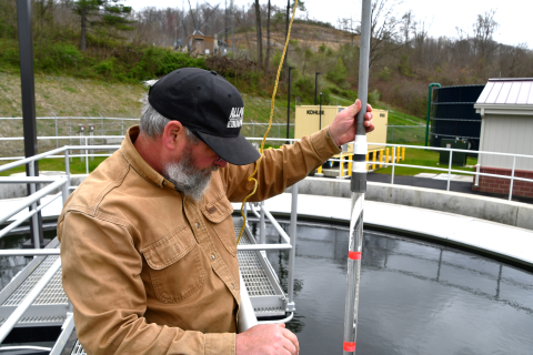 Man checking water sample.
