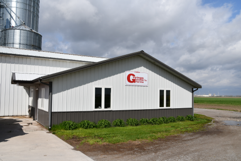 Farm buildings and grain storage towers.