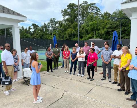 The Pelican Athletic Club General Manager Alix St. Pé gives a to Business Cooperative Services staff. ur to USDA Rural Development
