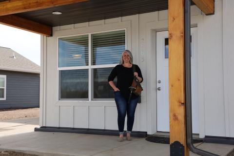 Woman standing by house
