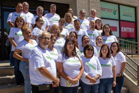 USDA Rural Development staff wearing their “Feds Feed Families” shirts pose outside of the Roadrunner Food Bank. 