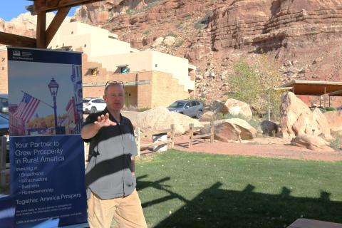 Bluff Dwellings Resort Owner, Jared Barrett speaking at the outdoor pavilion on the facility.