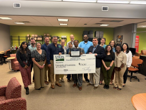 A group holds a ceremonial check to celebrate an investment from USDA Rural Development.