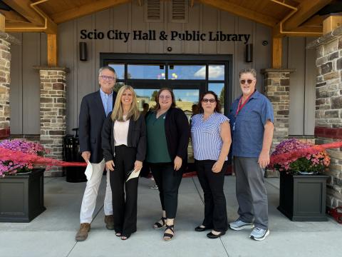 A group stands outside the Scio City Hall and Public Library building.