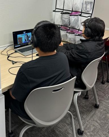 Students watching a therapist on a computer screen.