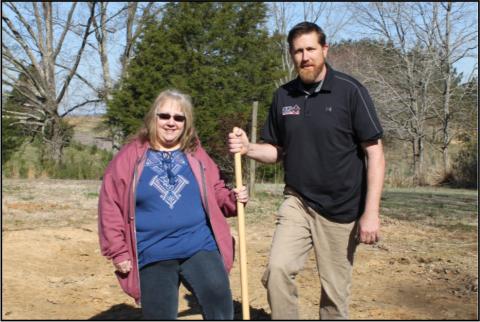 Gail Arnold, homeowner, and William Keith Dykes, WKD Construction use the gold shovel to break ground on her new home in Big Sandy.