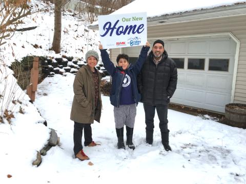 Tito Martes and family outside of their new home