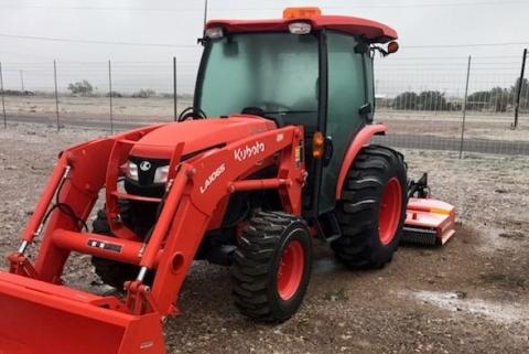 The new tractor with mower and front-end loader.