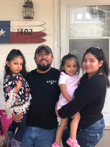 The Carillo family in front of their new home.