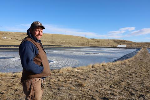 Man standing next to wastewater lagoon