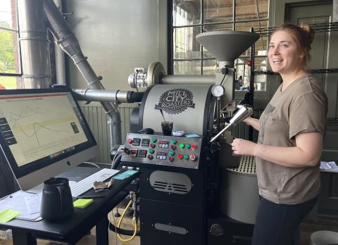 Tori Jackson monitoring the roasting process in the store.