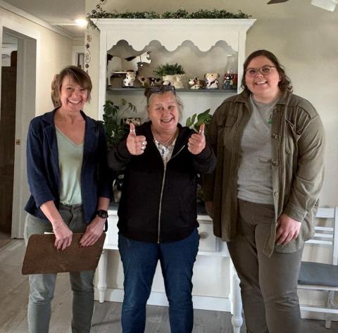 Three women pose for camera