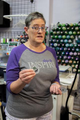 Ledford holding one of her customized tags