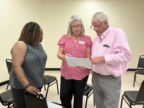 Laurette Tucker and Peggy Jordan confer with a resource fair attendee