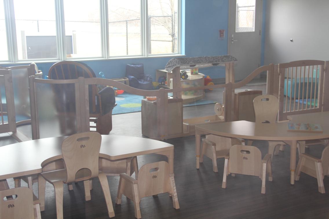 Chairs and tables furnish a room inside a childcare facility.