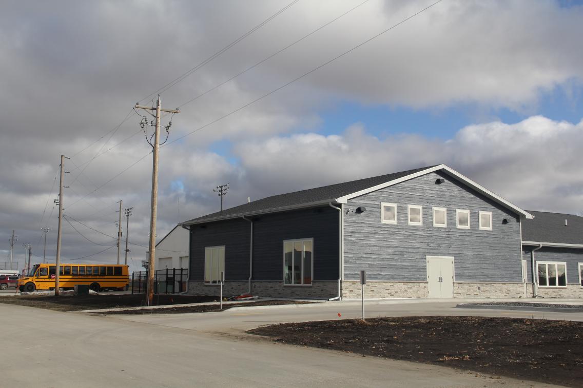 A school bus sits beside the new childcare facility in Griswold, Iowa