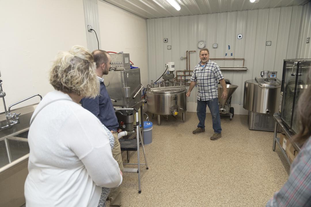 Scott Holt shows ice cream equipment to Rural Development staff