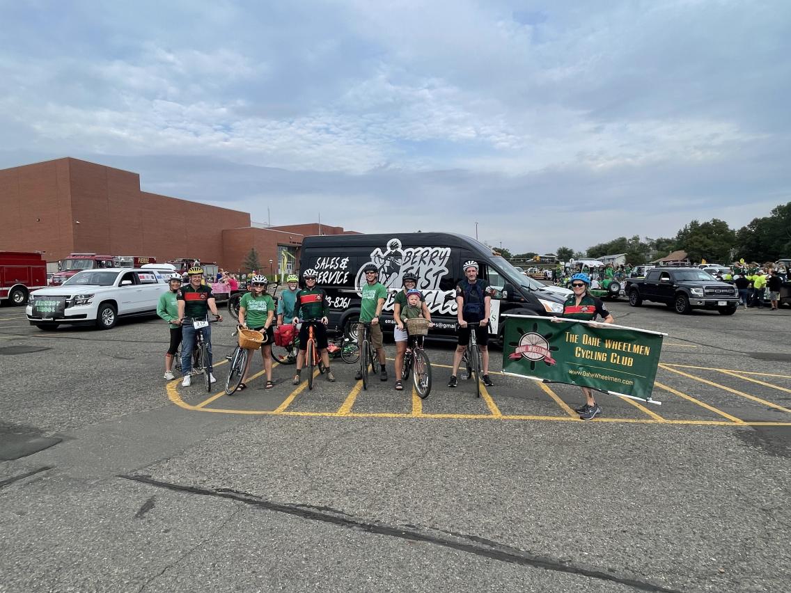 A group of bicyclists in front of Berry Fast Bicycle's mobile repair shop.