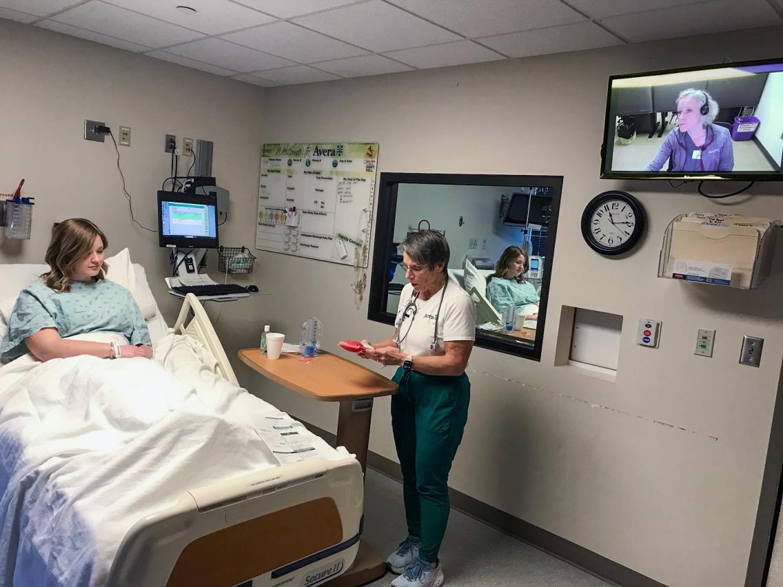 Medical staff at the bedside of a female patient