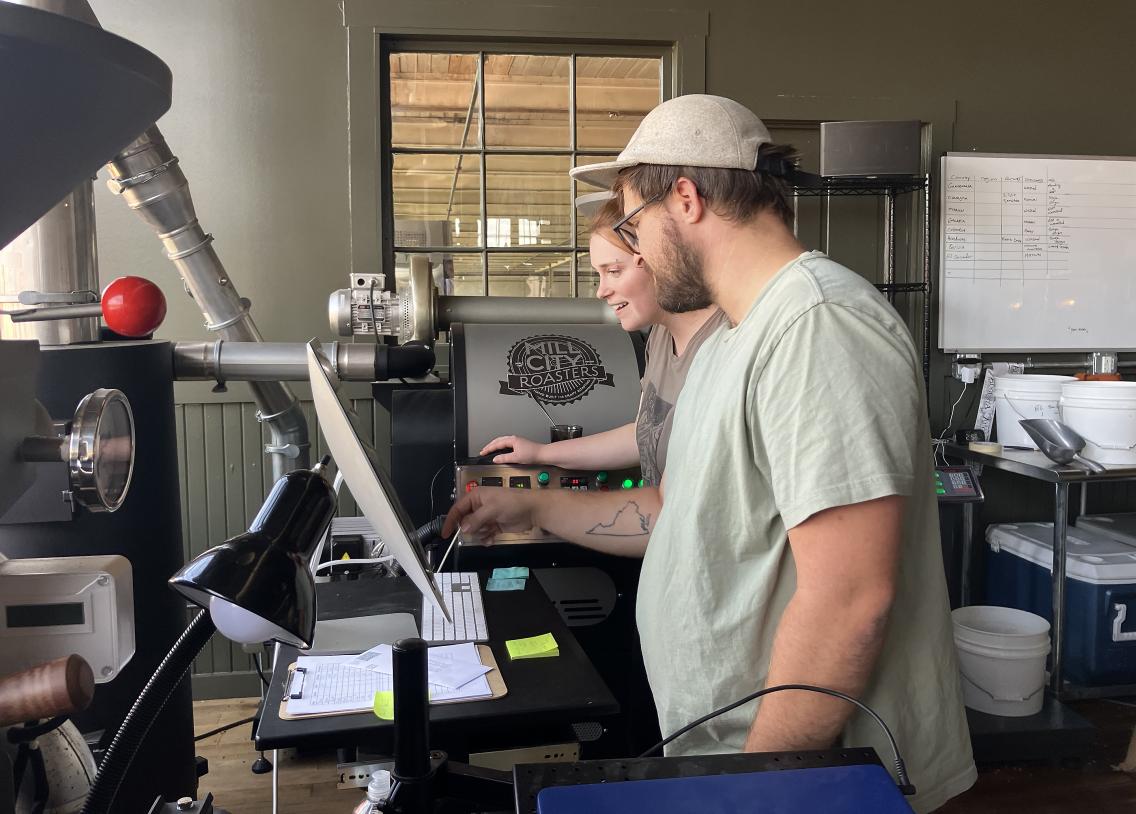 Jackson and Mallory checking displays on the coffee roaster