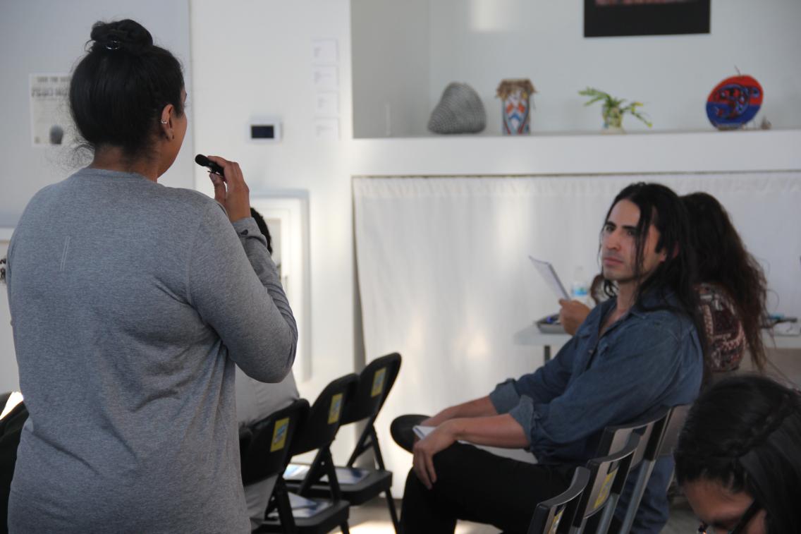 man looking at woman who is holding microphone