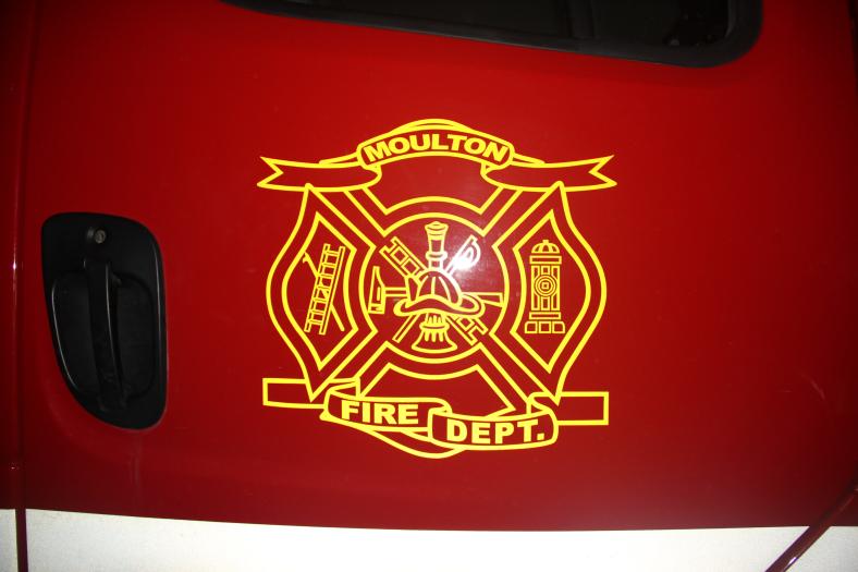 The emblem for Moulton's fire department is displayed on the firefighting vehicles.