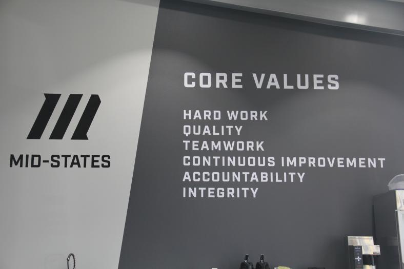 Inside the manufacturing building, a sign on the wall cites the company's core values