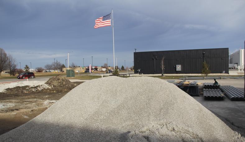 The American flag files high above the expansion construction site at Mid-States Material Handling and Fabrication 