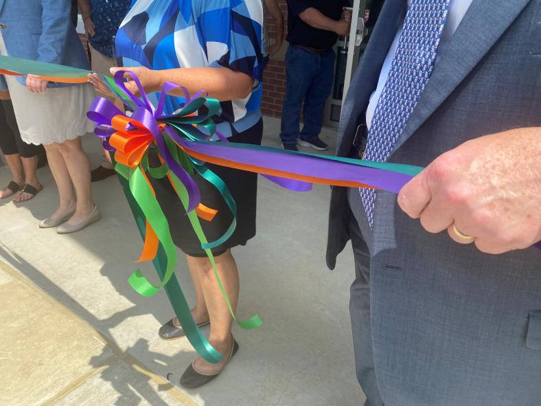 The multicolored ribbon represented “teal for sexual assault and domestic violence awareness, purple for homelessness awareness, green for mental health awareness, and then the orange, which is our YW color. All of these represent our signature programs.