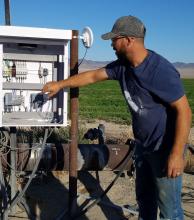 Operator managing controls on solar powered irrigation in Railroad Valley, Nevada.