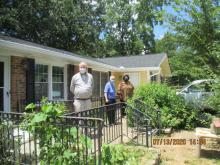 Ms. Dearing on her porch (center) social distance visiting from USDA housing program team members Wes and Qula.