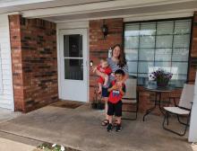 Photo of Hysell family. Sydney, Mylon, and Ghavon on front porch of their new home.
