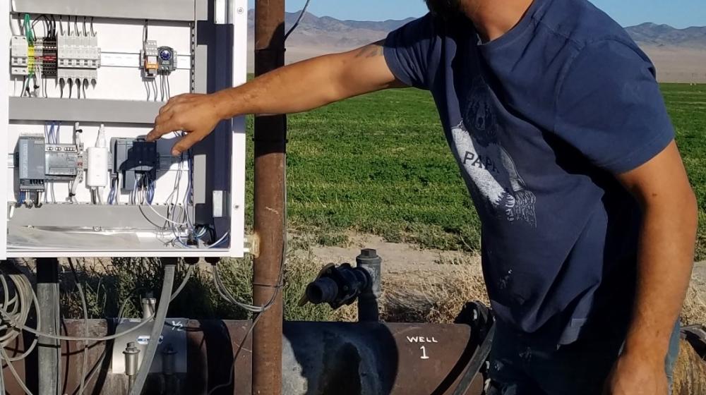 Operator managing controls on solar powered irrigation in Railroad Valley, Nevada.