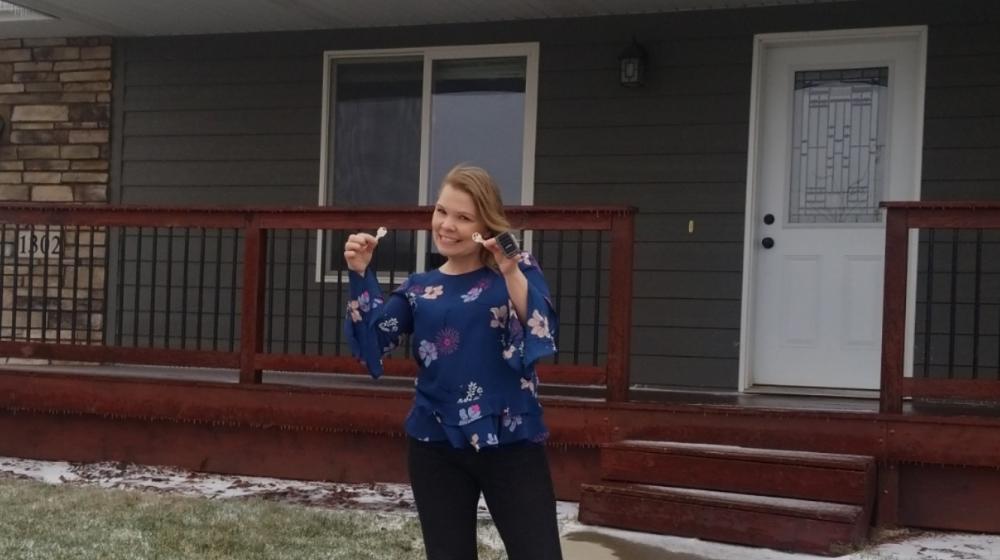 Crystal Dahl in front of her new home.