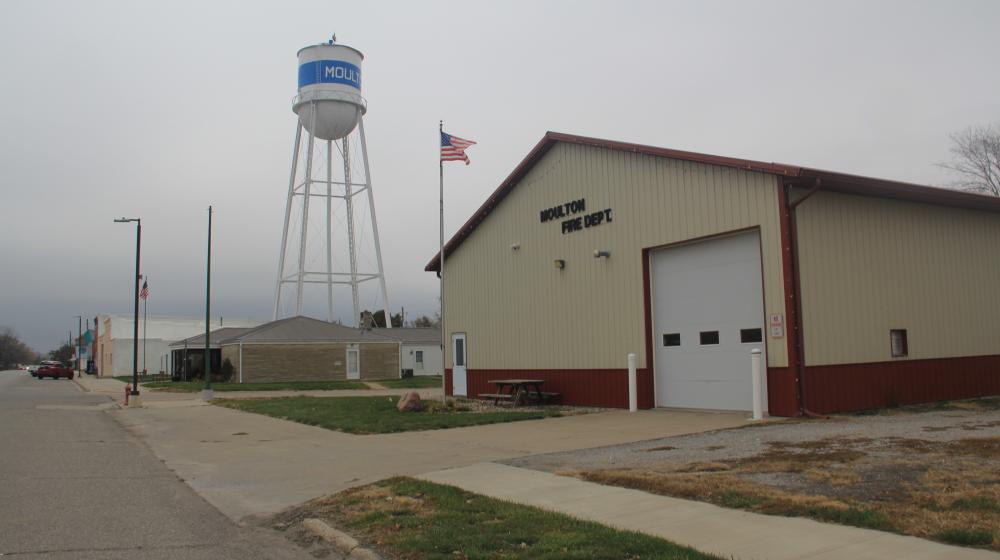 The Moulton volunteer fire department station with the US flag flying in front of in lies along the main street in town.