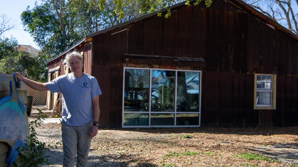 A man in front of a barn